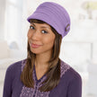 Front view #8306 Cotton Conductor Hat with Buckle Shown in Light Orchid with Shoulder Length Straight Halo Hairpiece (#8063) in (829) Sunkissed Brown 