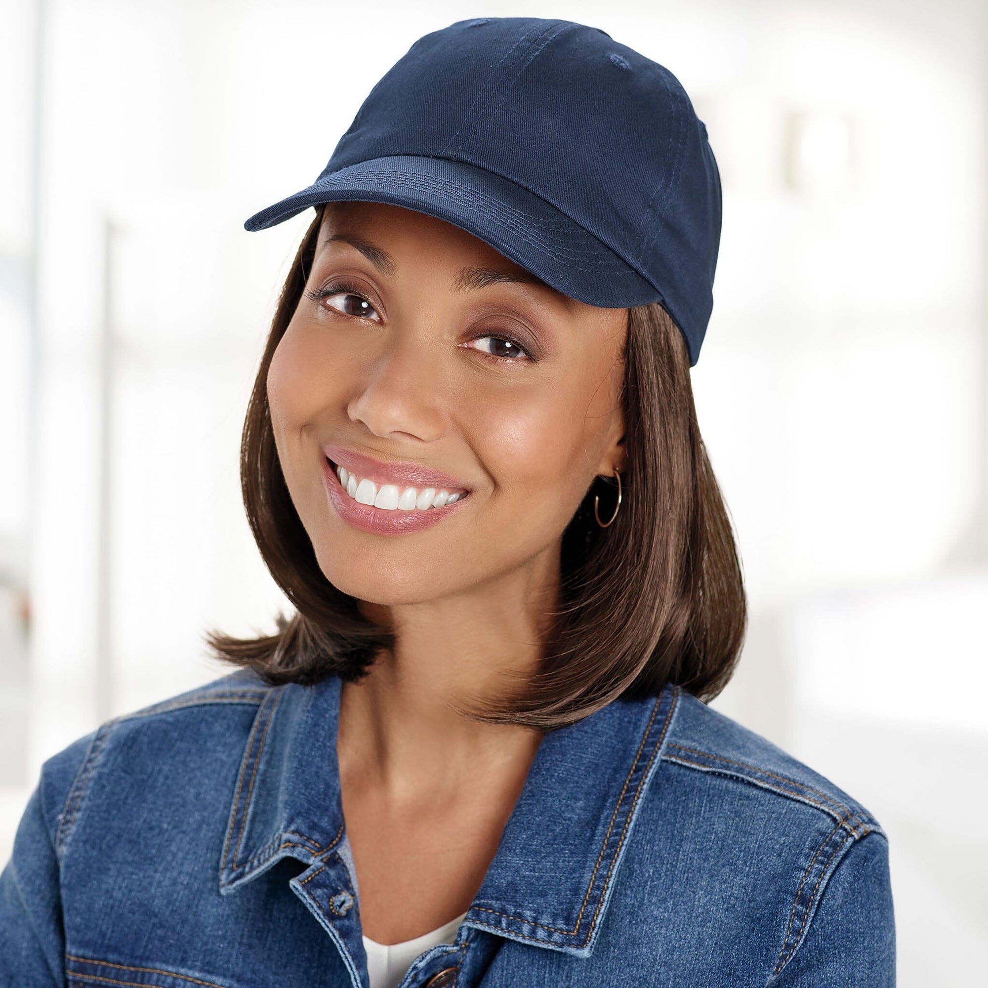 Front view #9441 Classic Wig with Navy Hat shown in 8H Med Brown with Golden Brown Highlights