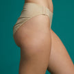 High Waist Brief with hook fasteners. Shown in beige, side view.